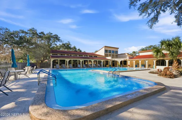 a view of a house with pool porch and sitting area