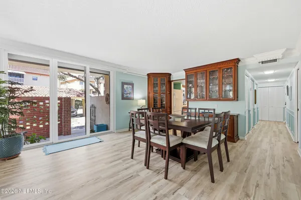 a view of a dining room with furniture and wooden floor