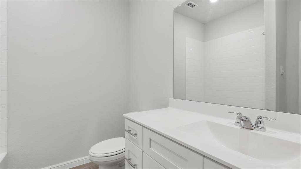9621 Austin Holw Road Fort Worth, TX 76036 - Photo 14 of 23 a bathroom with a sink a toilet and a mirror