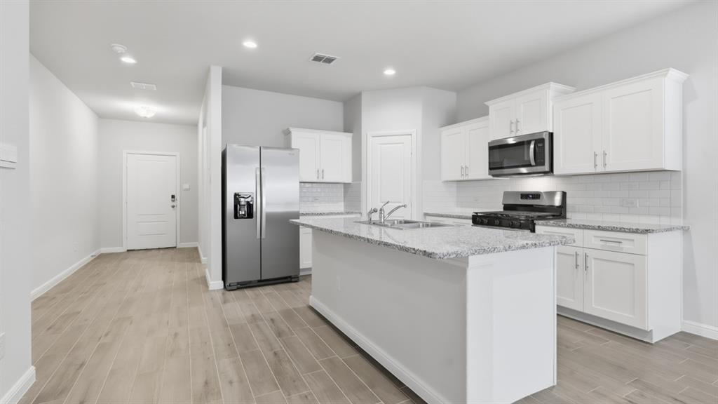 9621 Austin Holw Road Fort Worth, TX 76036 - Photo 1 of 23 a kitchen with stainless steel appliances granite countertop a refrigerator sink and white cabinets