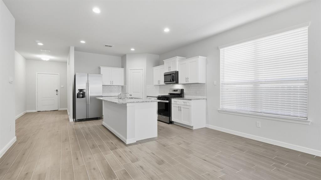 9621 Austin Holw Road Fort Worth, TX 76036 - Photo 4 of 23 a kitchen with white cabinets and white appliances