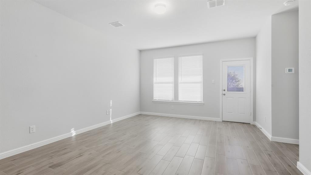 9621 Austin Holw Road Fort Worth, TX 76036 - Photo 7 of 23 an empty room with wooden floor and windows