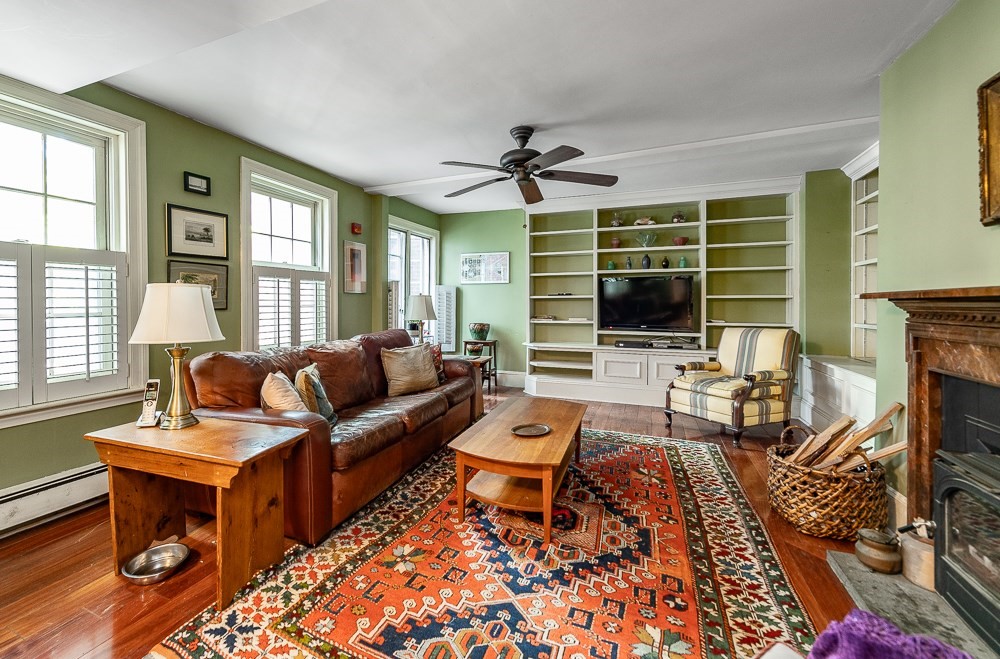 a living room with furniture fireplace and a flat screen tv