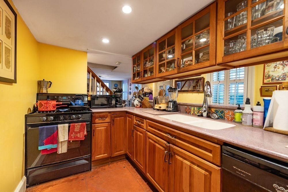 26 Cedar Street Boston, MA 02129 - Photo 14 of 19 a kitchen with stainless steel appliances granite countertop a stove and a sink