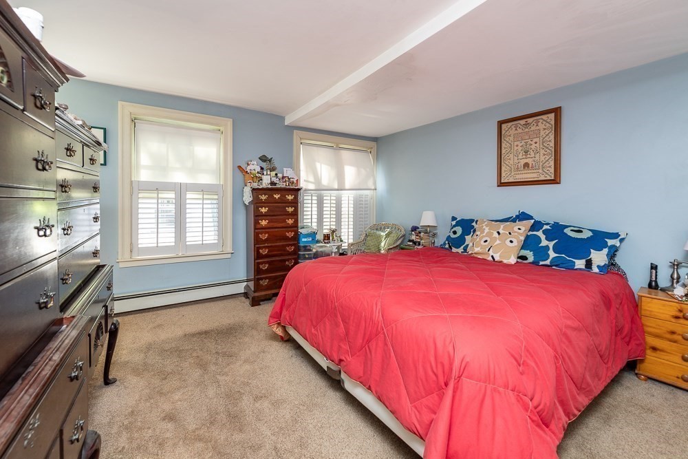 26 Cedar Street Boston, MA 02129 - Photo 7 of 19 a bed sitting in a bedroom next to a window