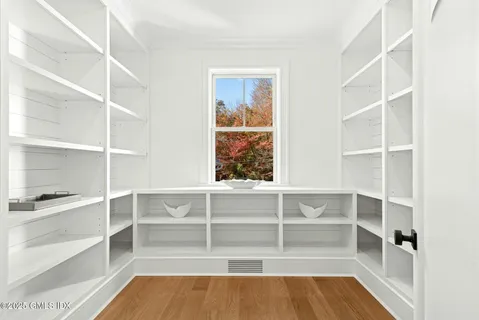 a view of walk in closet with empty racks