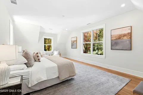 a bedroom with a large bed and a window