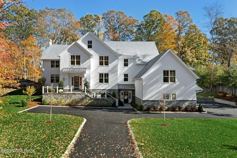 a view of a white house with a yard