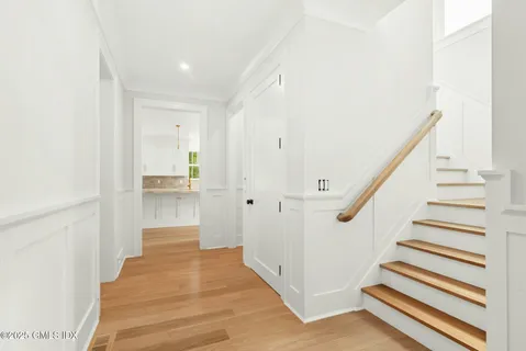 a view of entryway and hall with wooden floor