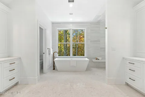 a bathroom with a bathtub and window
