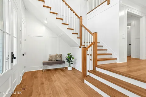a view of entryway and hall with wooden floor