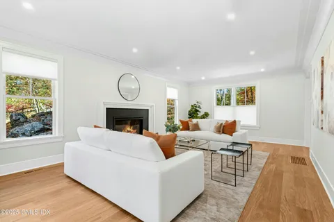 a living room with furniture wooden floor and a fireplace