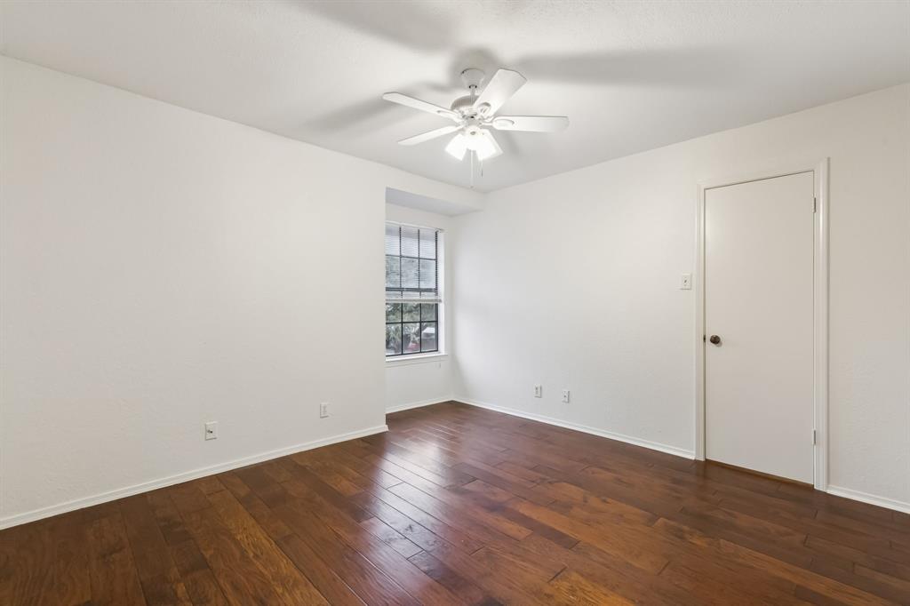 4748 Old Bent Tree Lane, Unit 1808 Dallas, TX 75287 - Photo 10 of 28 an empty room with wooden floor fan and windows