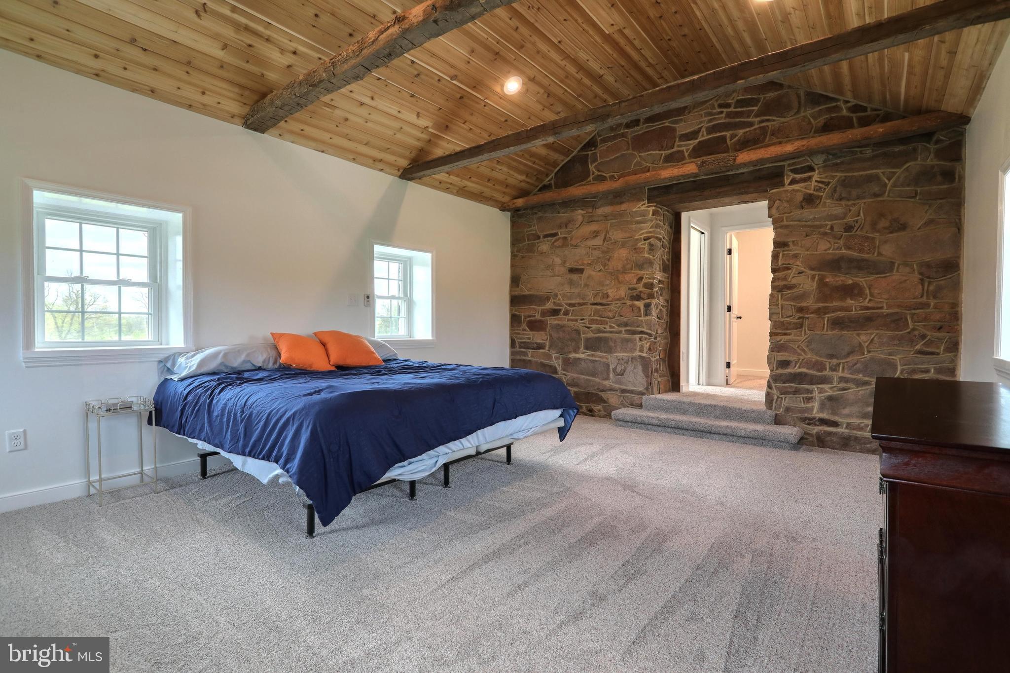 270 Cedar Ridge Road New Oxford, PA 17350 - Photo 73 of 129 a bedroom with a bed and a brick wall painting