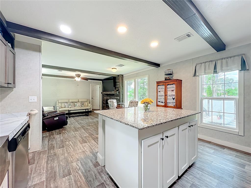 2815 Southwest 89th Place Ocala, FL 34476 - Photo 13 of 36 a kitchen with sink stove and cabinets
