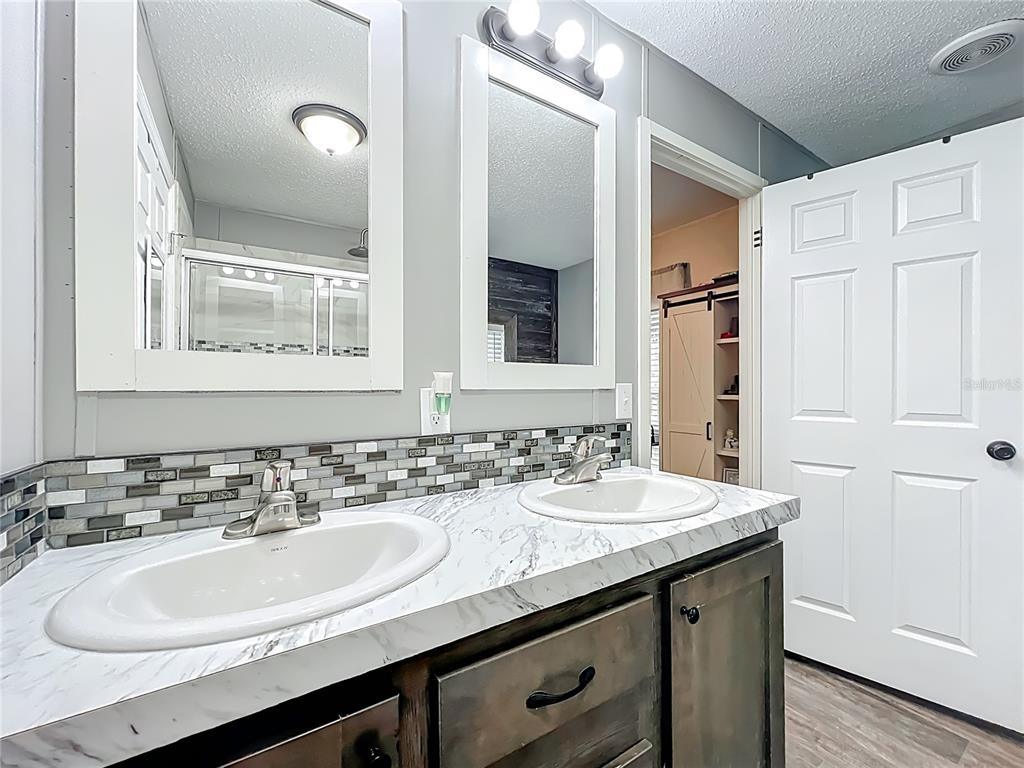 2815 Southwest 89th Place Ocala, FL 34476 - Photo 18 of 36 a bathroom with a granite countertop sink and a mirror