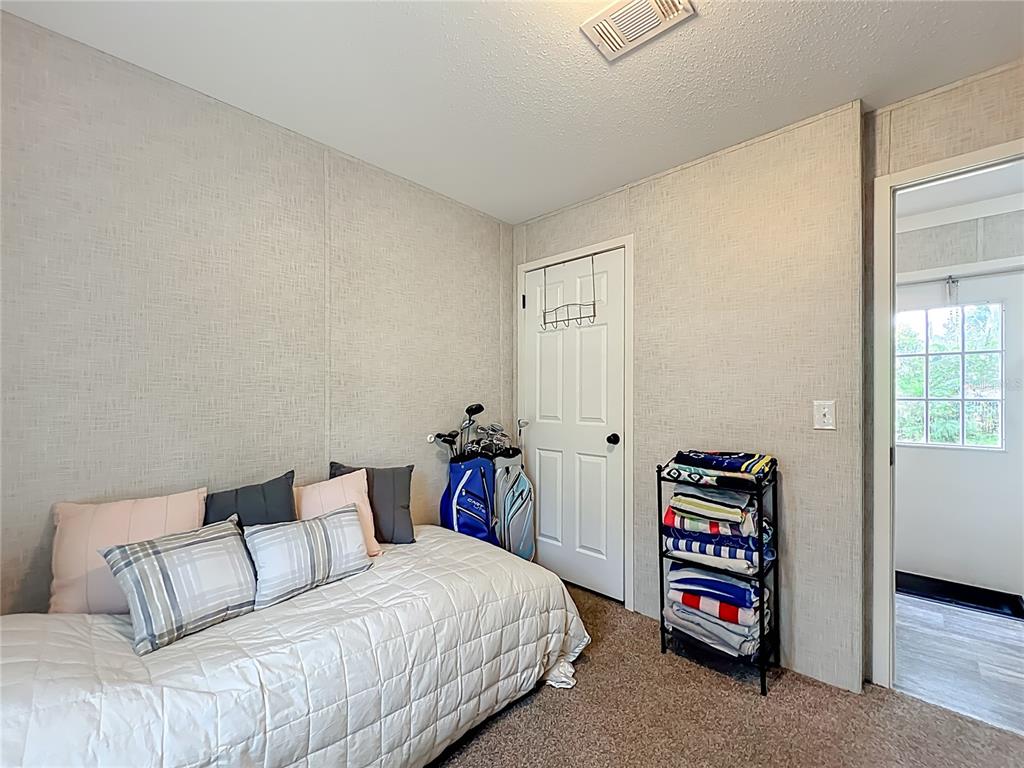 2815 Southwest 89th Place Ocala, FL 34476 - Photo 19 of 36 a bedroom with a bed and a dresser