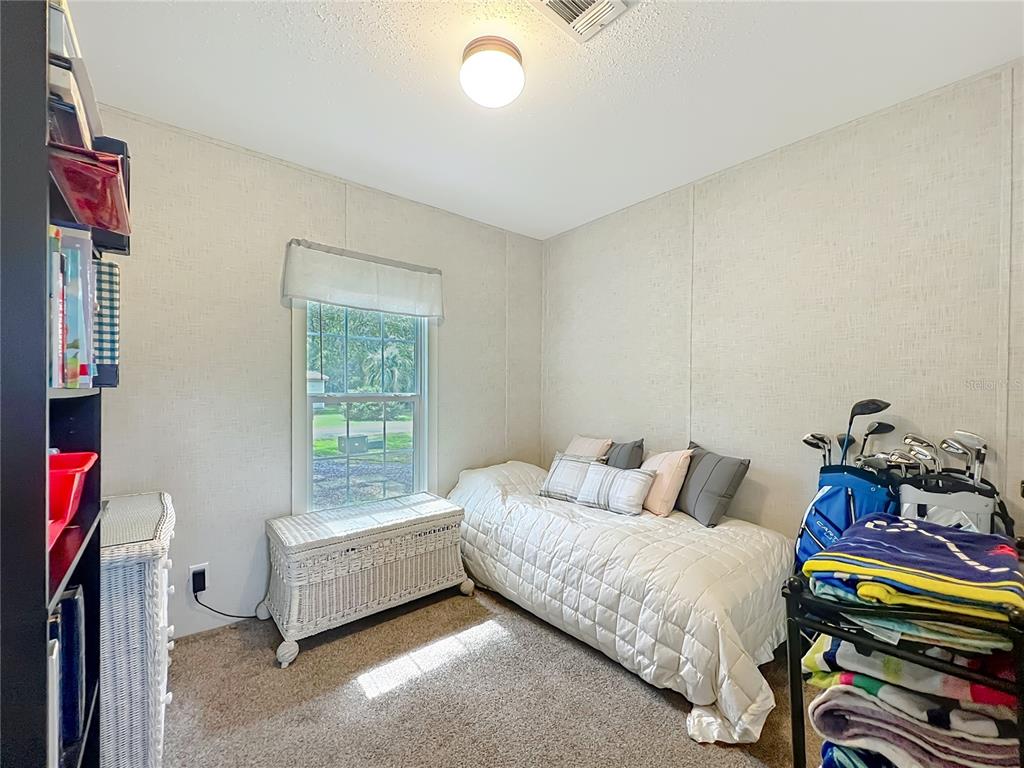 2815 Southwest 89th Place Ocala, FL 34476 - Photo 20 of 36 a bedroom with furniture and a window