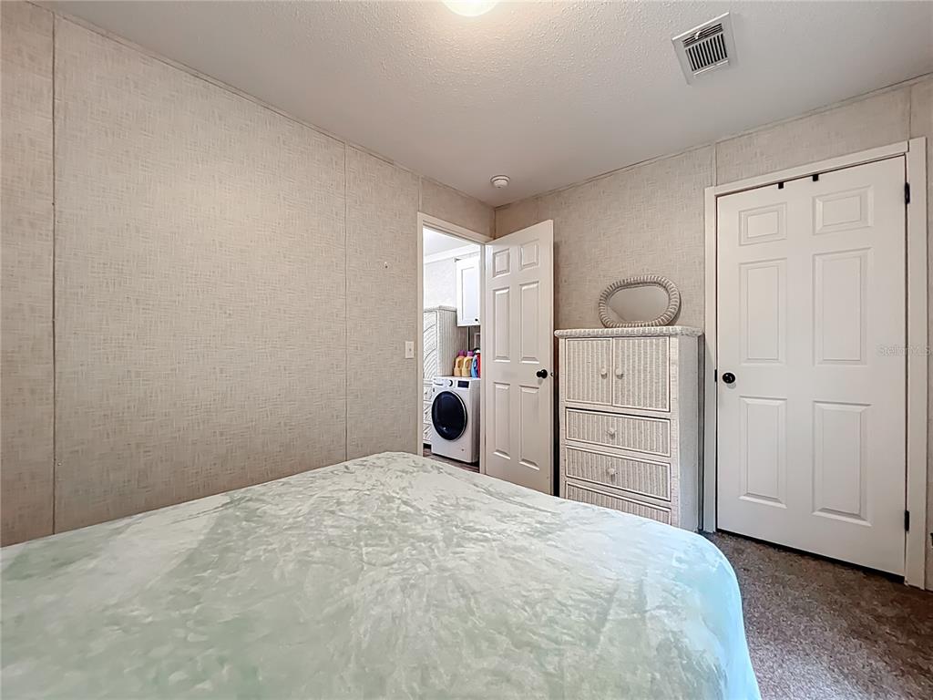 2815 Southwest 89th Place Ocala, FL 34476 - Photo 21 of 36 a bedroom with a bed and a window