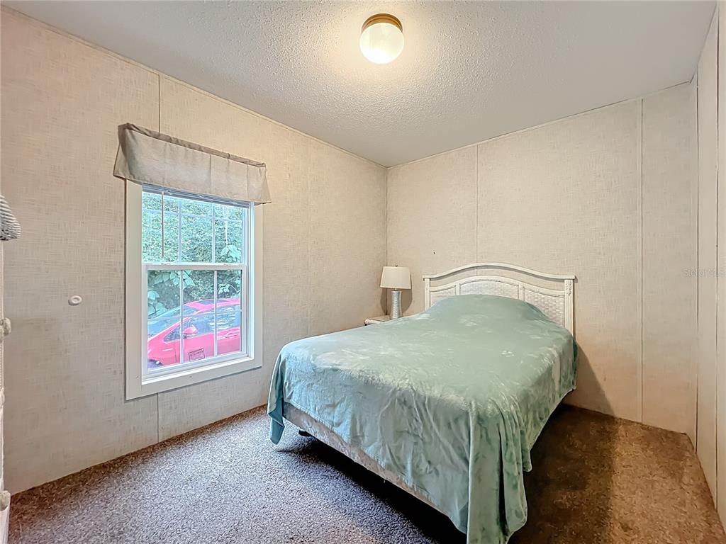 2815 Southwest 89th Place Ocala, FL 34476 - Photo 23 of 36 a bedroom with a bed and window