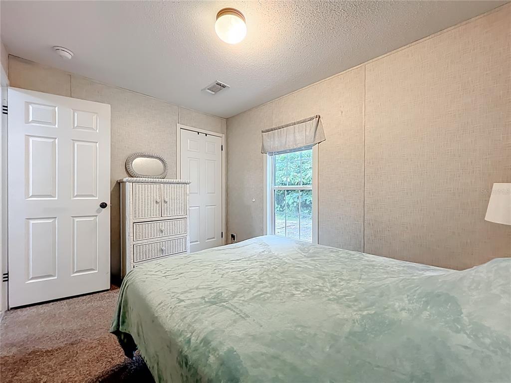 2815 Southwest 89th Place Ocala, FL 34476 - Photo 24 of 36 a bedroom with a bed and a window