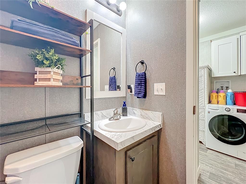2815 Southwest 89th Place Ocala, FL 34476 - Photo 26 of 36 a bathroom with a sink a toilet and a mirror