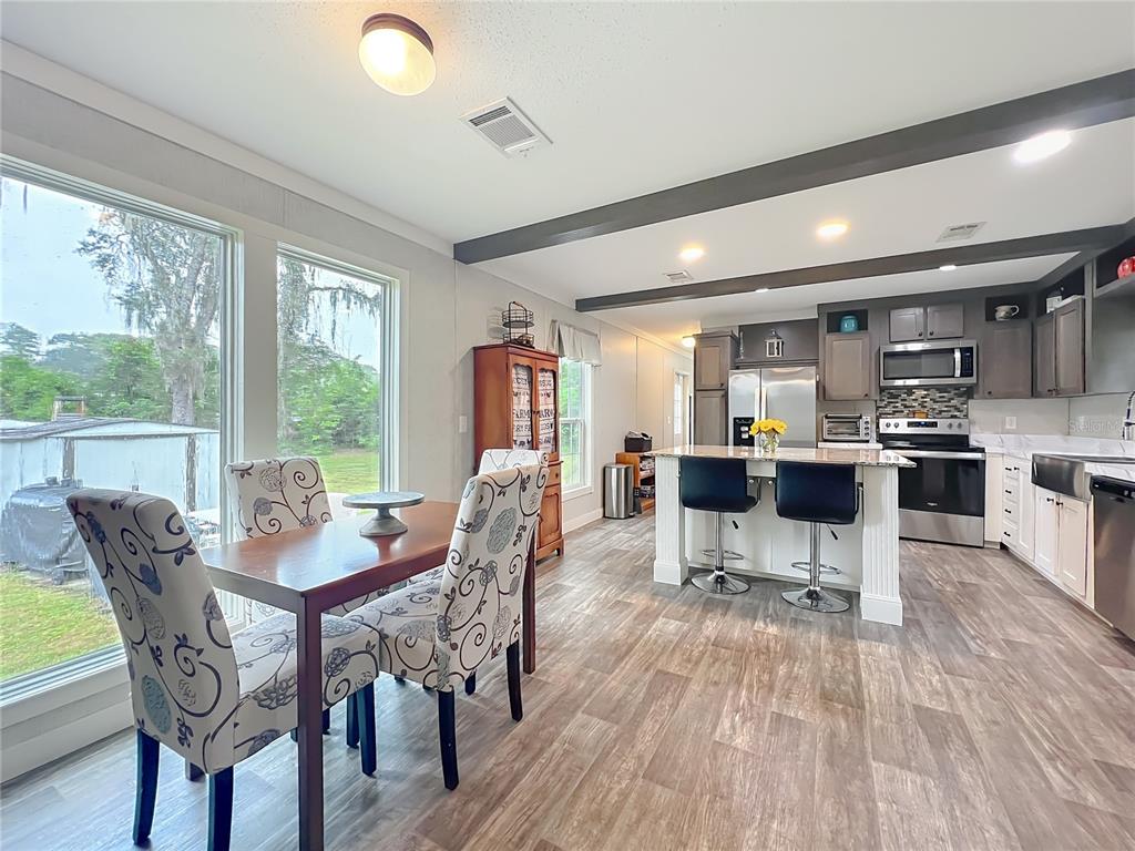 2815 Southwest 89th Place Ocala, FL 34476 - Photo 3 of 36 a view of a dining room with furniture window and wooden floor