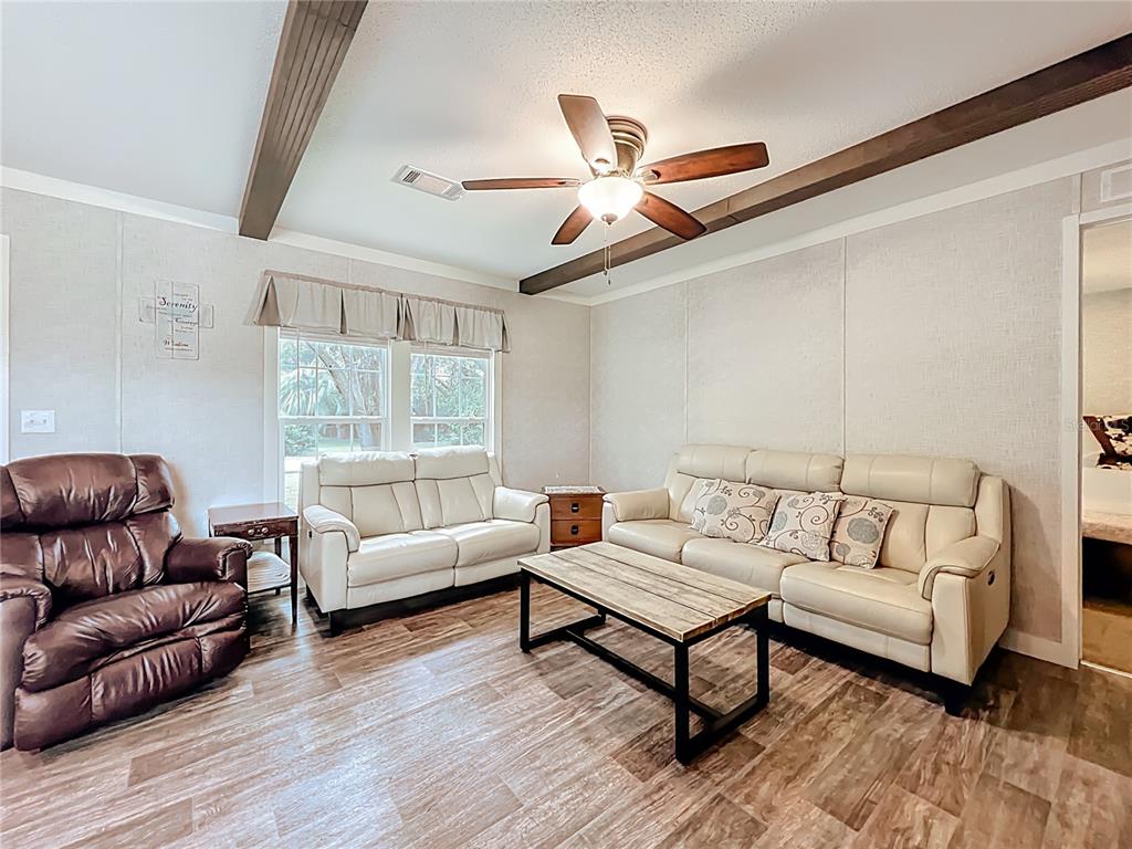2815 Southwest 89th Place Ocala, FL 34476 - Photo 8 of 36 a living room with furniture and a large window