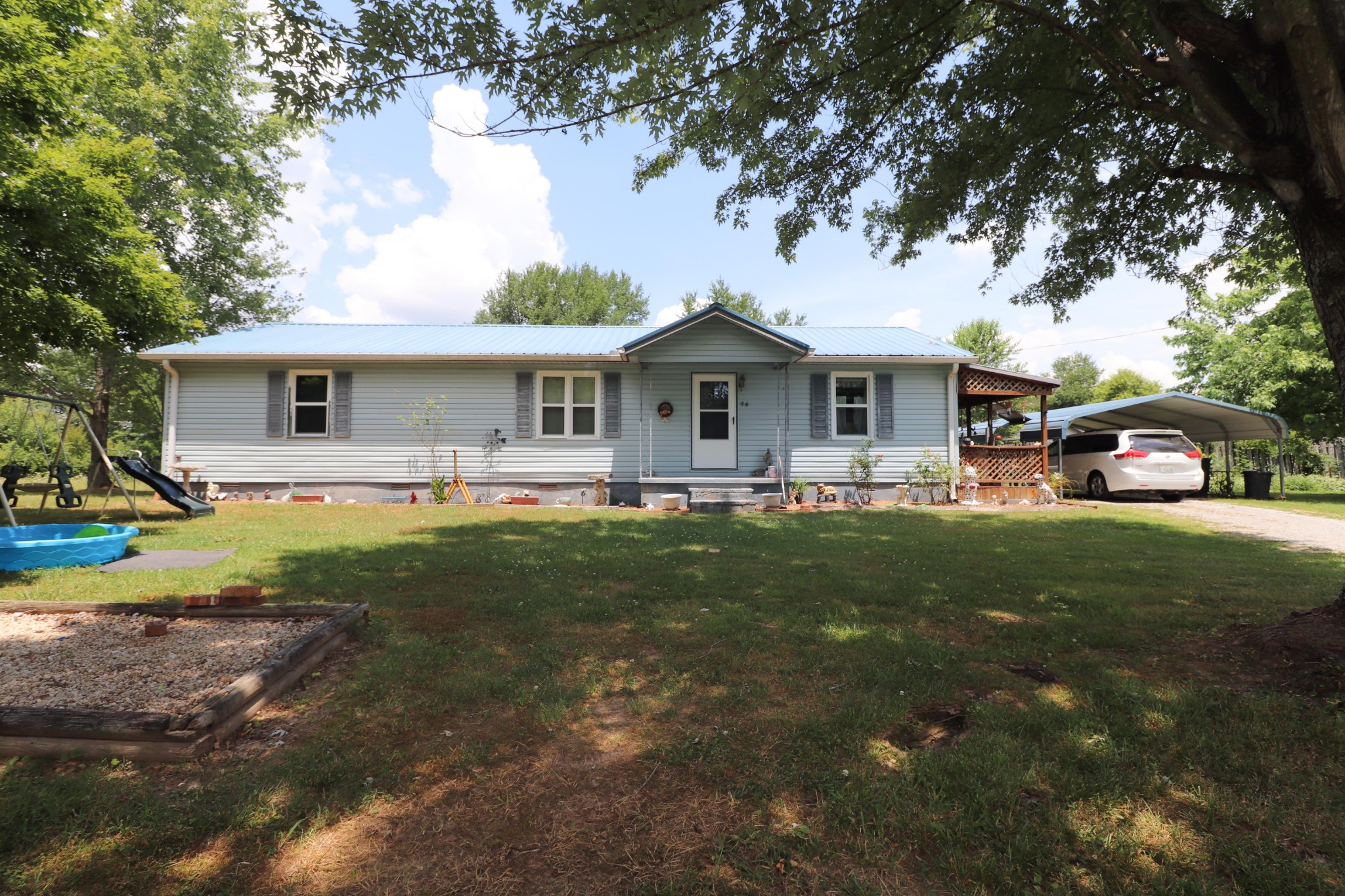 a front view of house with yard and green space