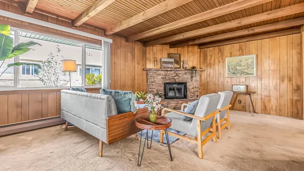 a living room with furniture a fireplace and a table