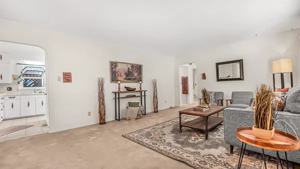 a living room with furniture and a rug