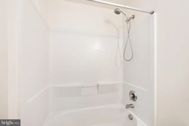 a bathroom with a shower and a bath tub