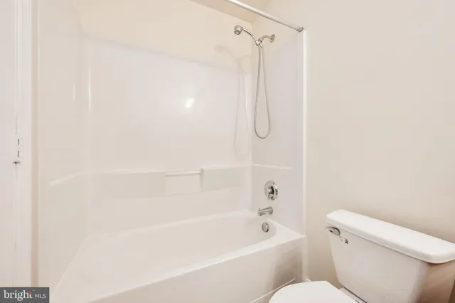 a bathroom with a shower and a toilet