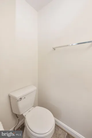a white toilet sitting next to a shower