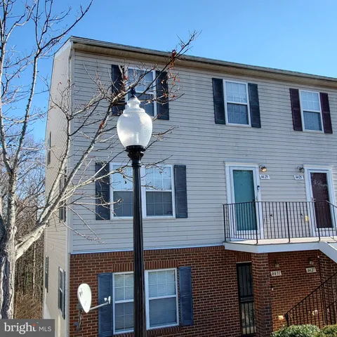 a front view of a house with a iron gate