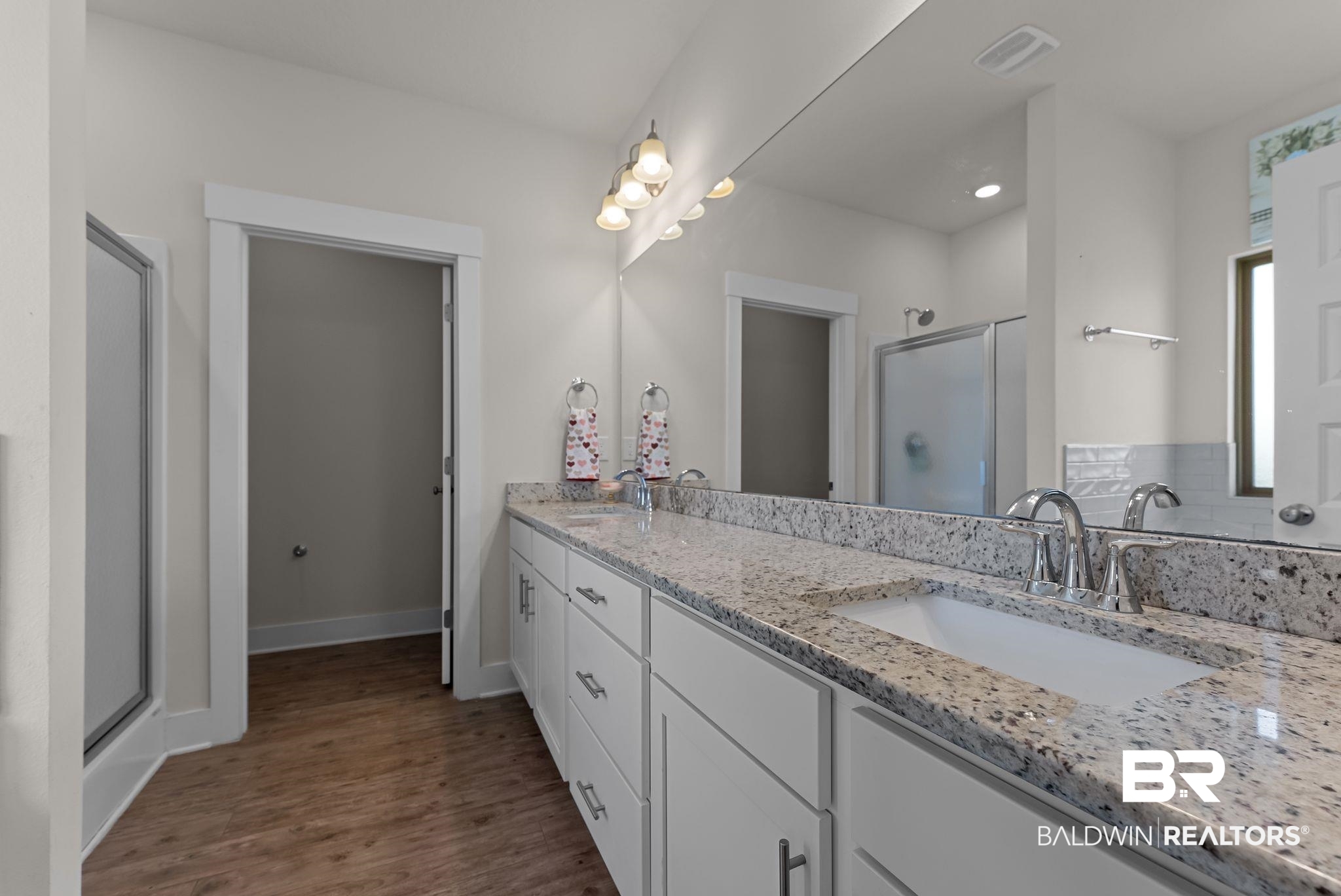 16607 Prado Loop Loxley, AL 36551 - Photo 33 of 46 Double vanity featuring granite countertops, undermount sinks, and chrome fixtures