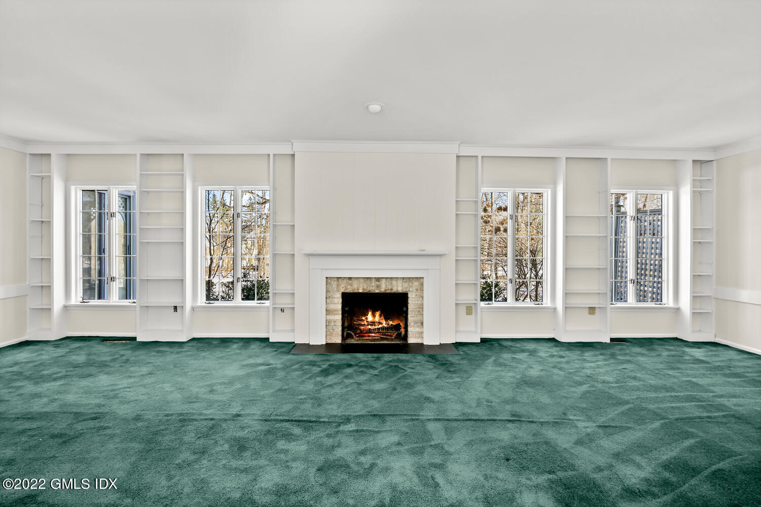32 Peaceable Street Ridgefield, CT 06877 - Photo 17 of 38 a view of an empty room with windows and fireplace