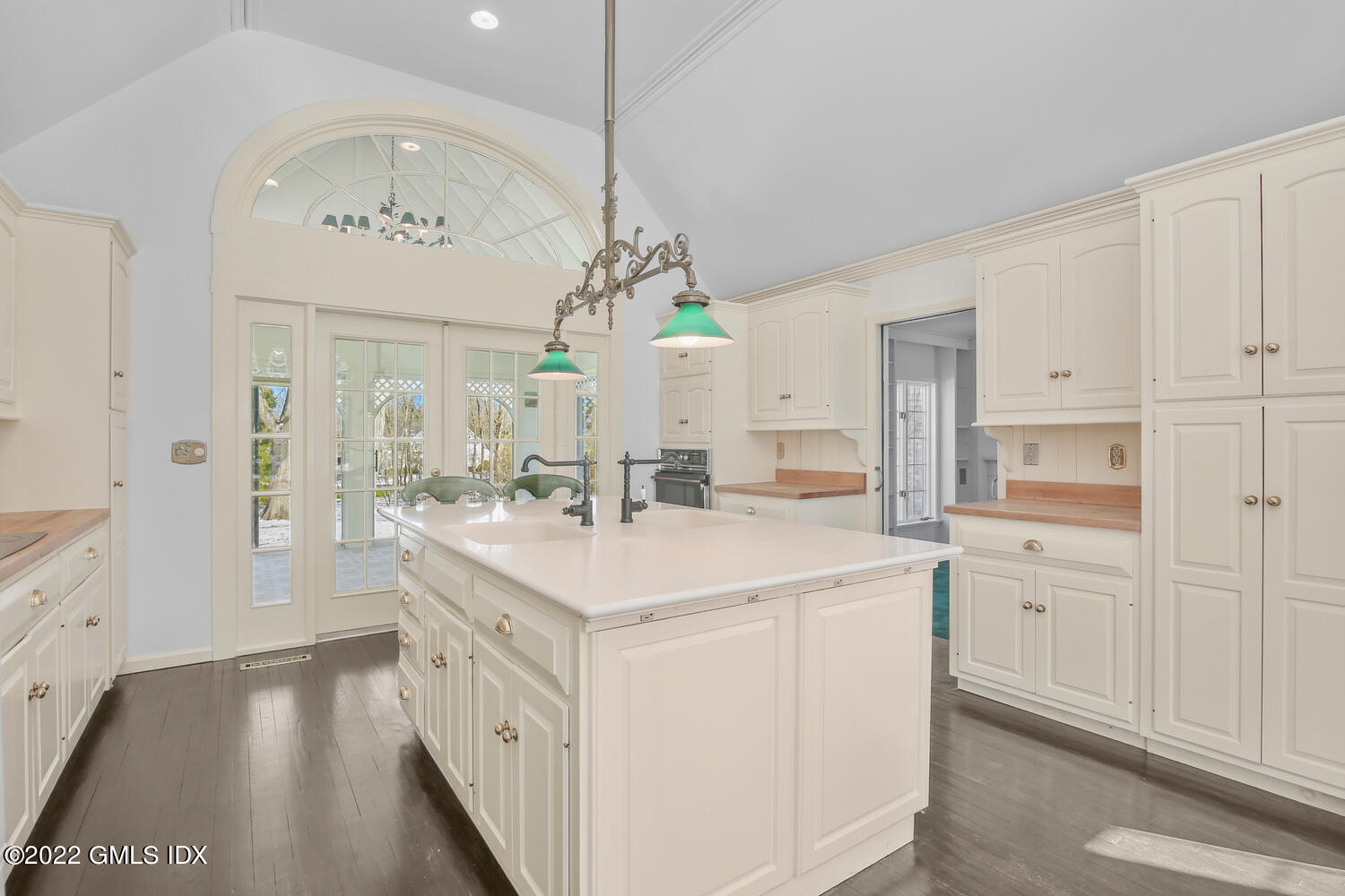 32 Peaceable Street Ridgefield, CT 06877 - Photo 6 of 38 a large white kitchen with a sink and dishwasher with white cabinets