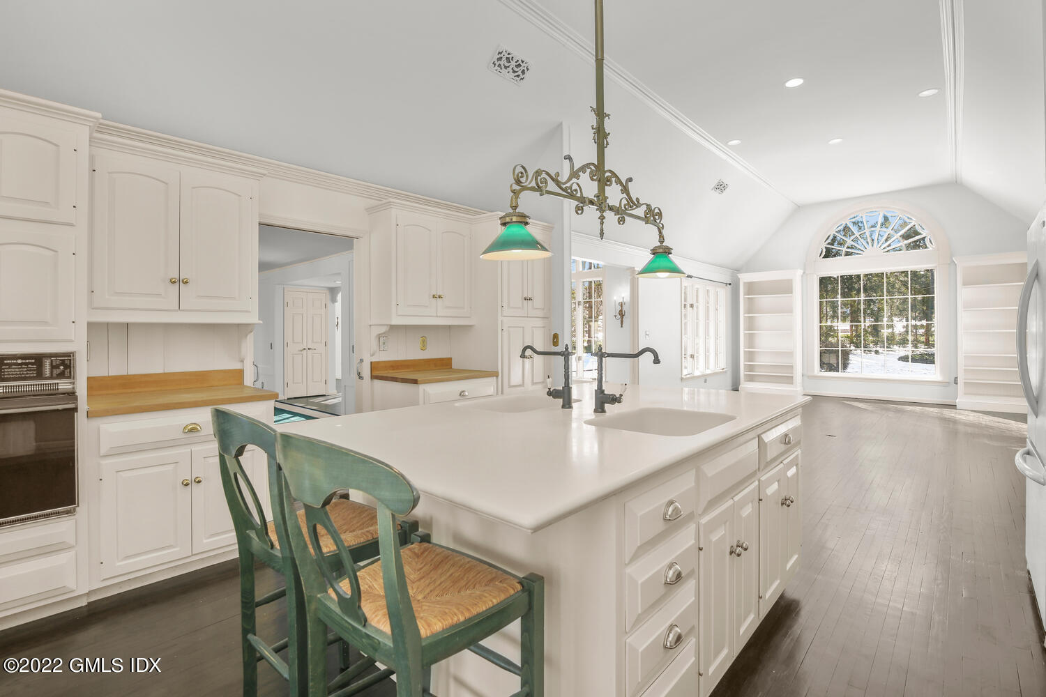 32 Peaceable Street Ridgefield, CT 06877 - Photo 7 of 38 a kitchen with stainless steel appliances kitchen island granite countertop a stove a sink a dining table and chairs