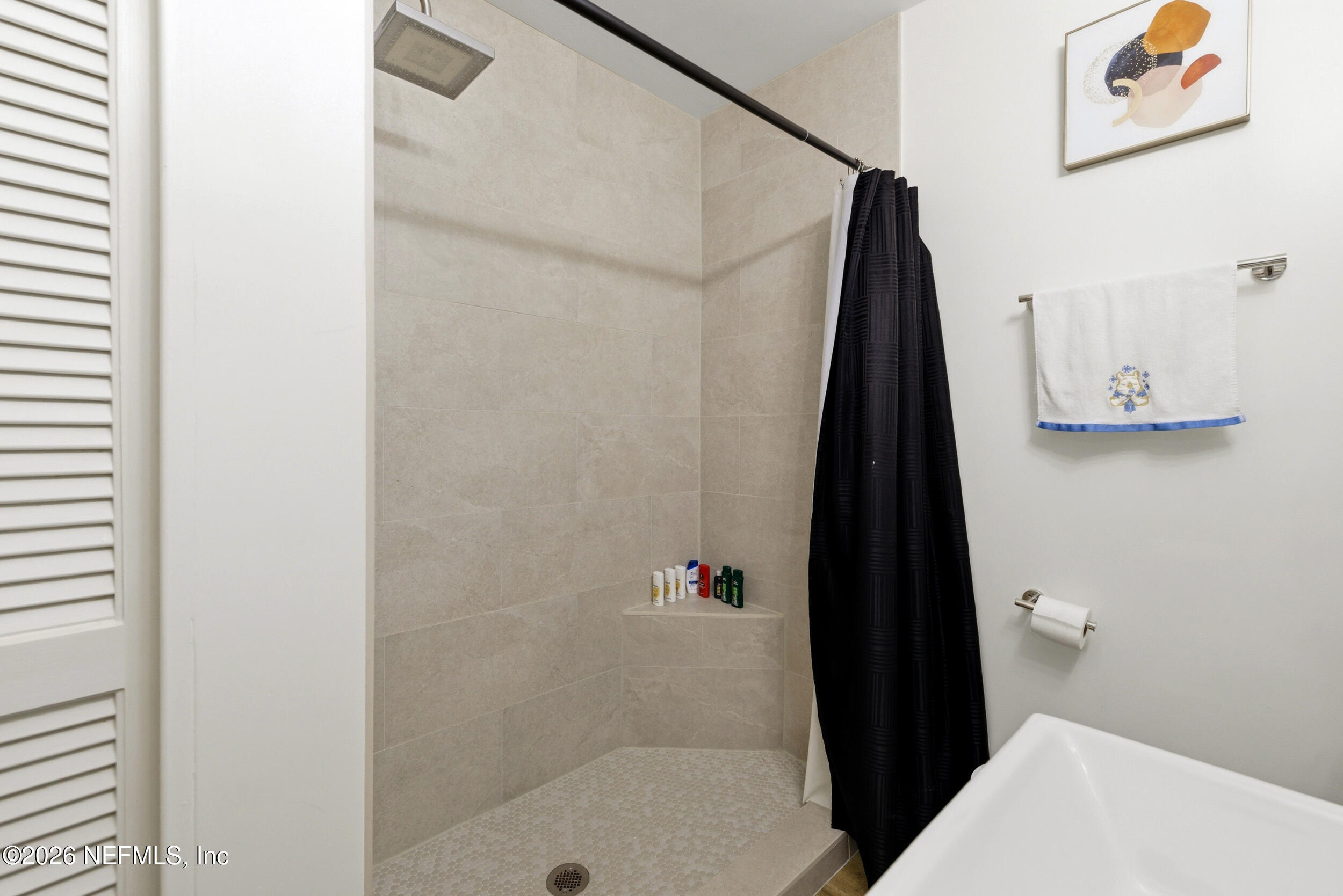 7484 Spinola Road Jacksonville, FL 32217 - Photo 38 of 63 a bathroom with a shower and a sink