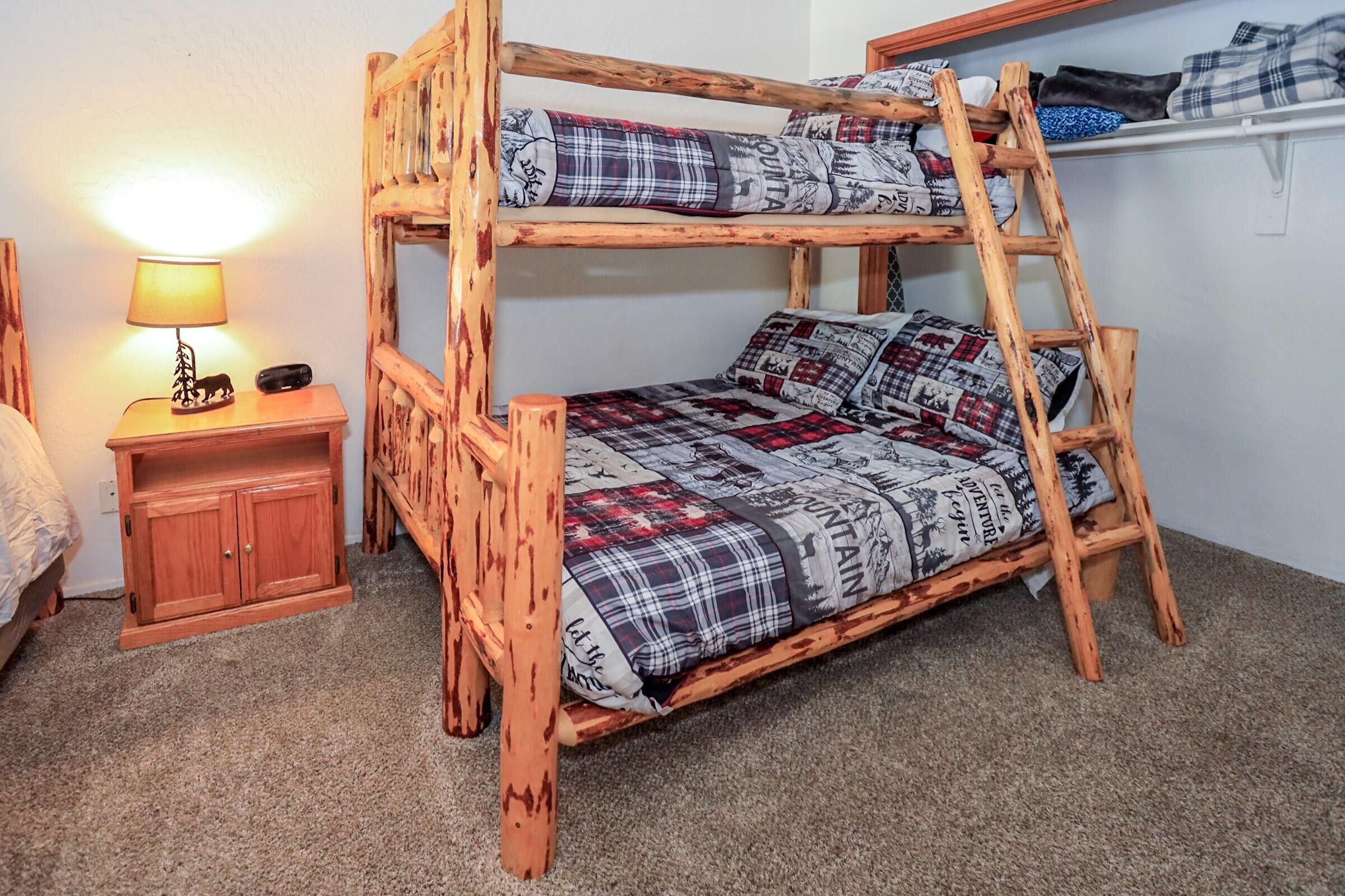 42638 Moonridge Road Big Bear Lake, CA 92315 - Photo 25 of 39 a bed sitting in a bedroom next to a lamp