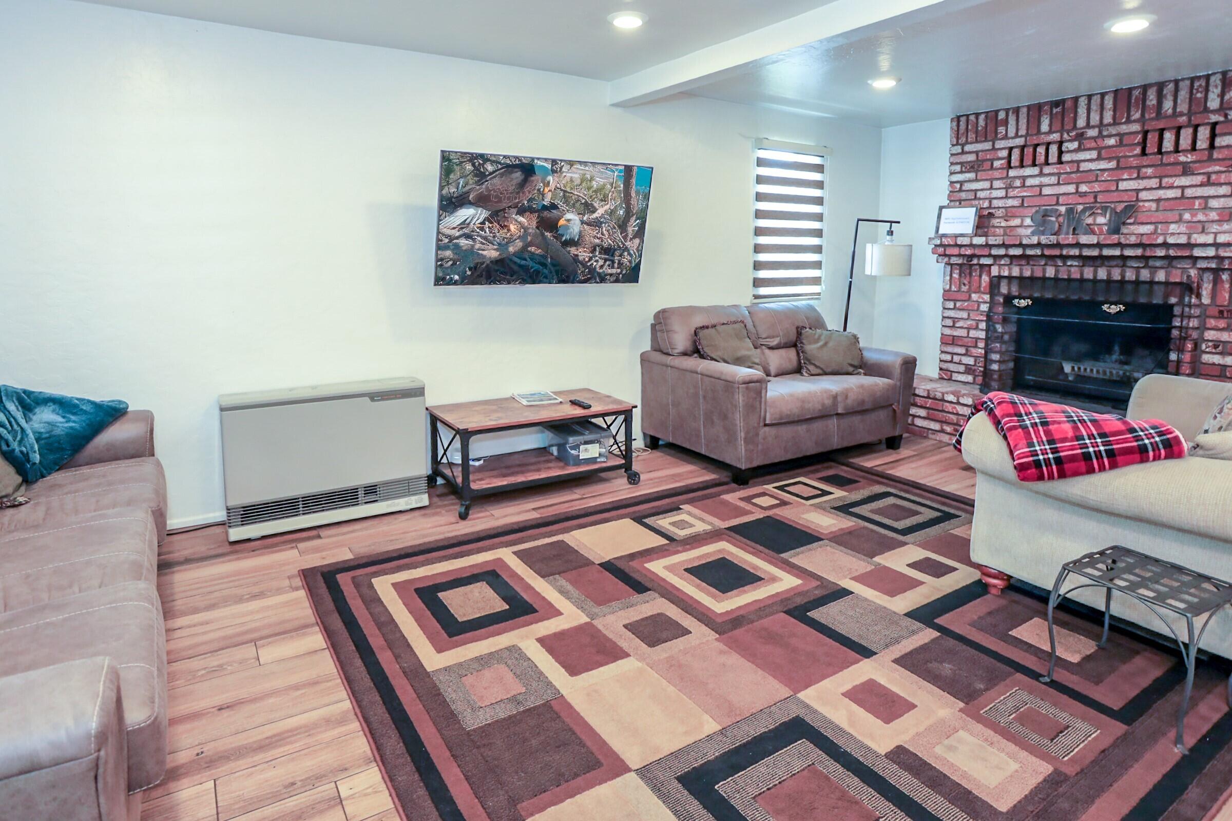 42638 Moonridge Road Big Bear Lake, CA 92315 - Photo 5 of 39 a living room with furniture and a fireplace