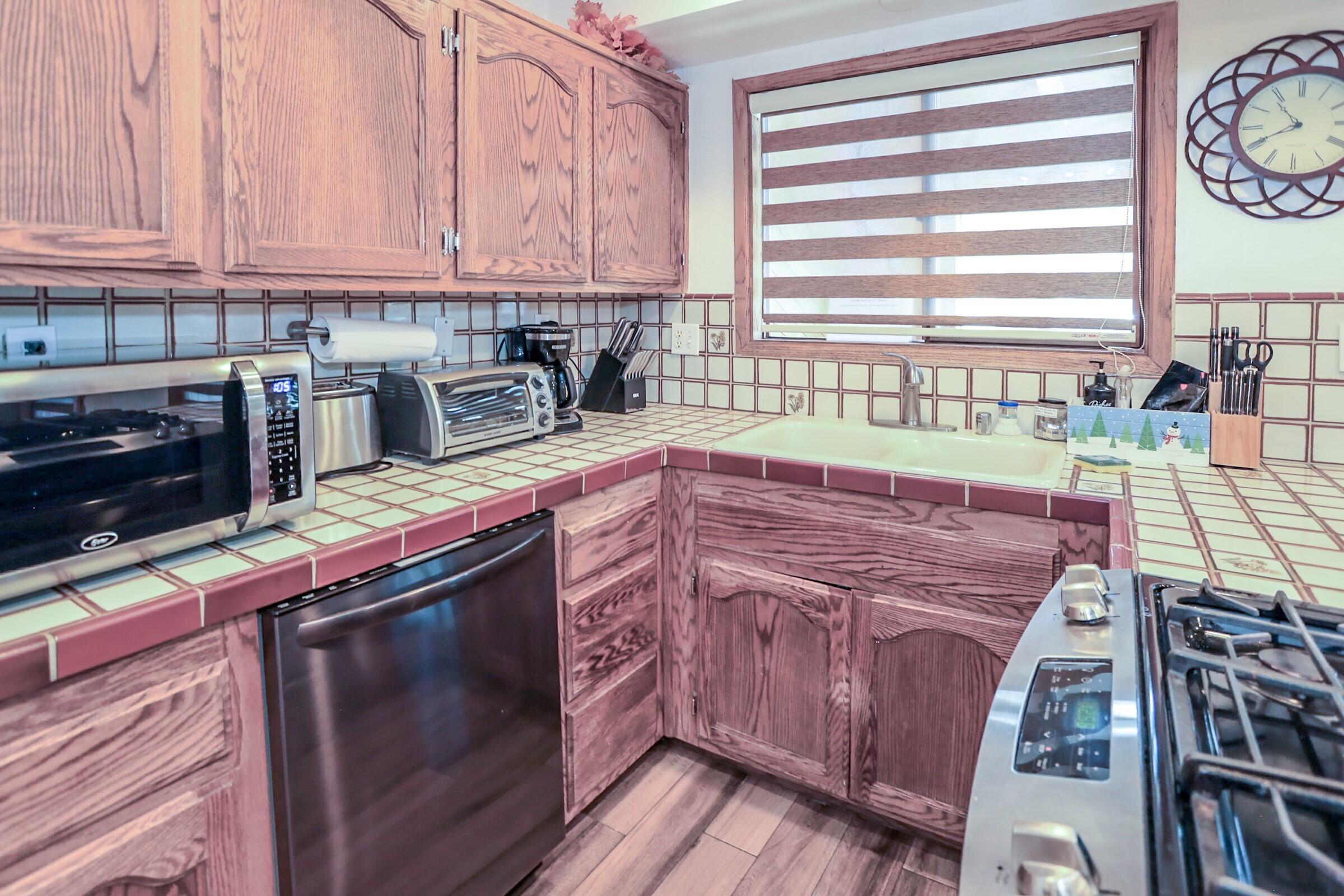 42638 Moonridge Road Big Bear Lake, CA 92315 - Photo 7 of 39 a kitchen with stainless steel appliances granite countertop a stove a sink and a microwave