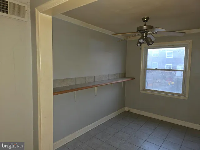 a view of room with window and ceiling fan