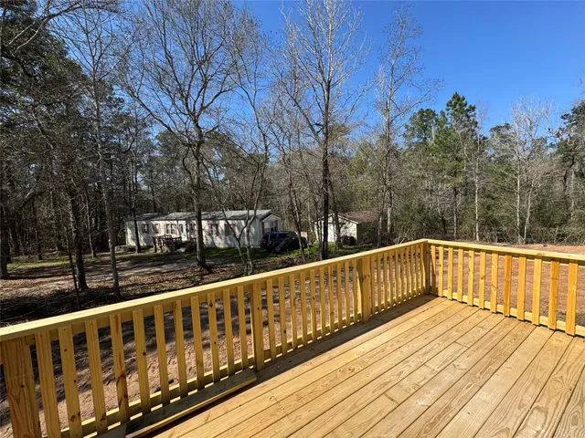 a view of a wooden deck with trees