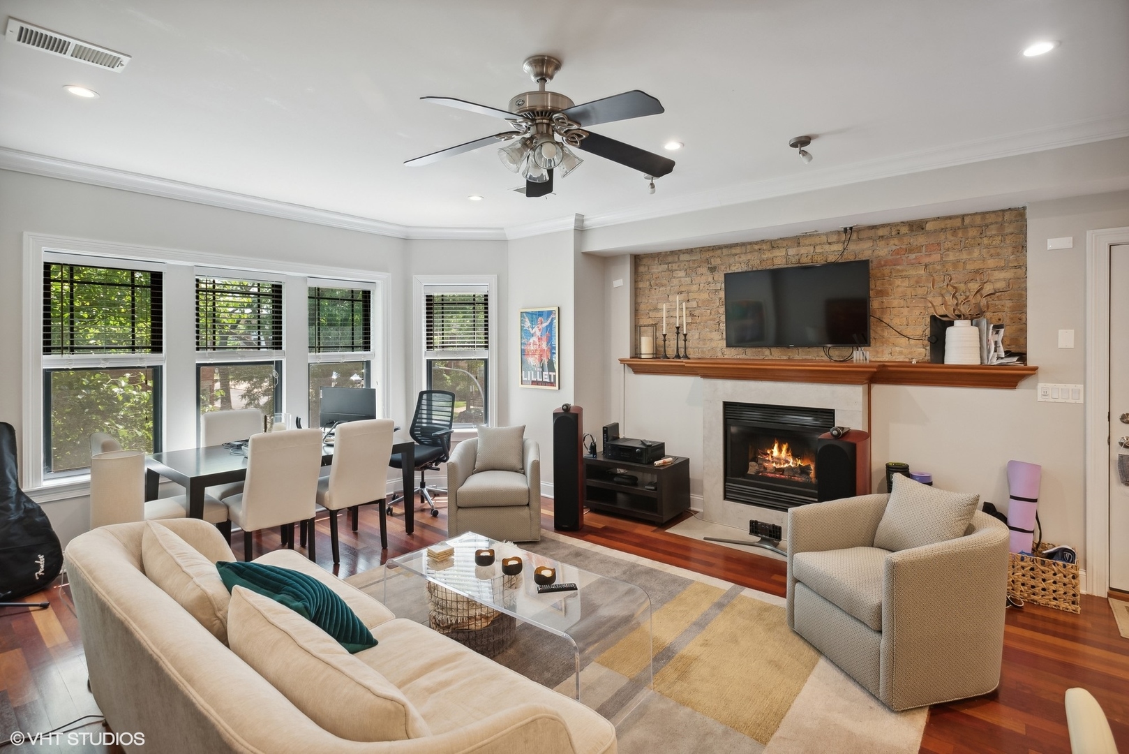 2324 West Argyle Street, Unit 2E Chicago, IL 60625 - Photo 3 of 14 a living room with furniture a fireplace and a flat screen tv