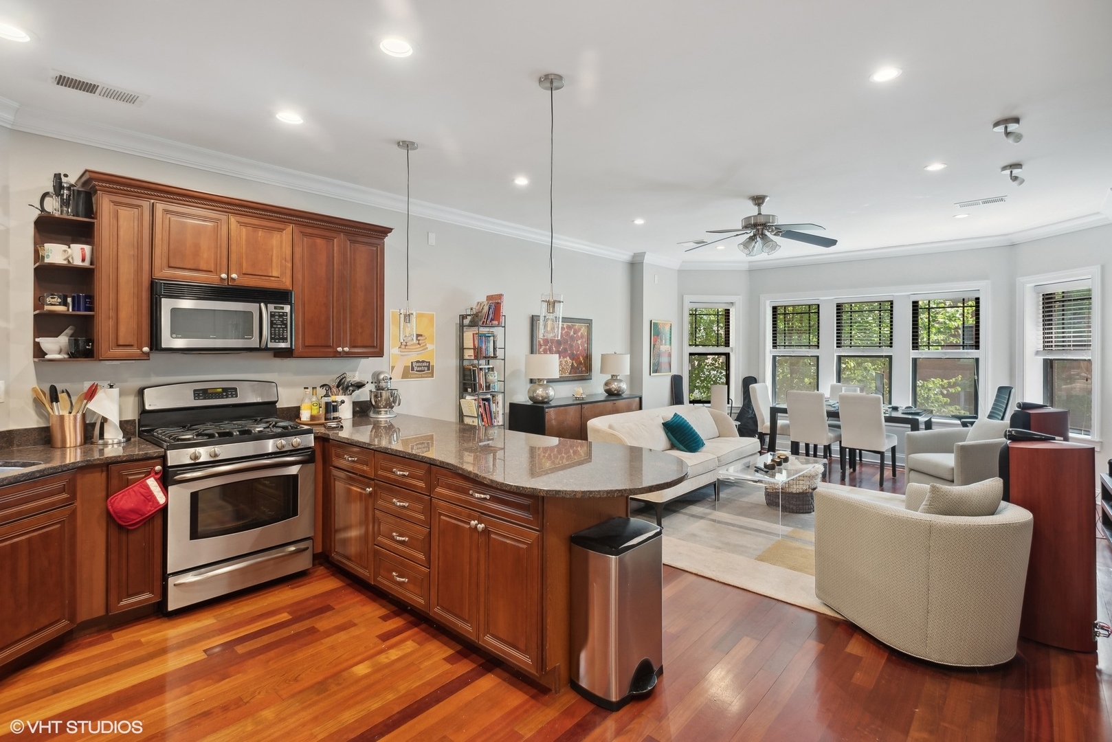 2324 West Argyle Street, Unit 2E Chicago, IL 60625 - Photo 6 of 14 a living room with stainless steel appliances granite countertop furniture wooden floor and a view of kitchen
