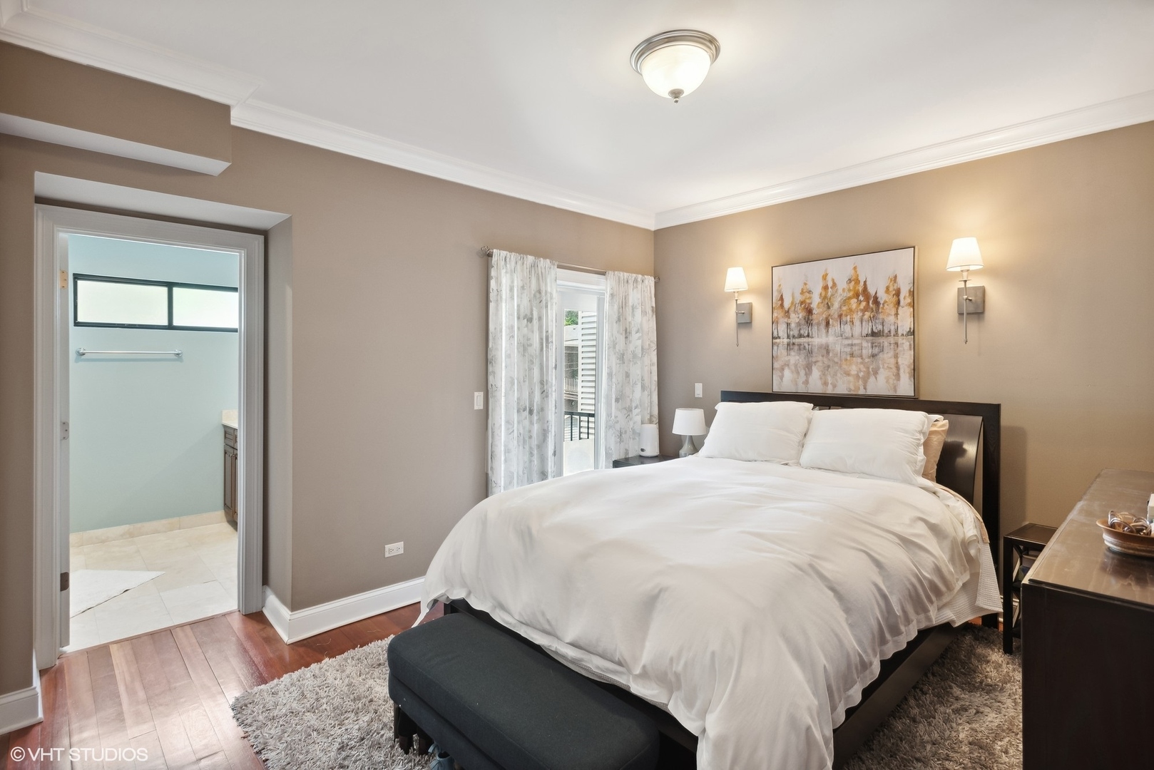 2324 West Argyle Street, Unit 2E Chicago, IL 60625 - Photo 8 of 14 a large bed sitting in a bedroom next to a bathroom