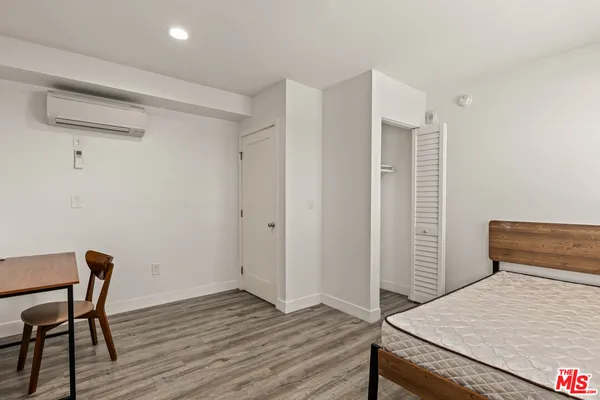 a view of a room with wooden floor and window