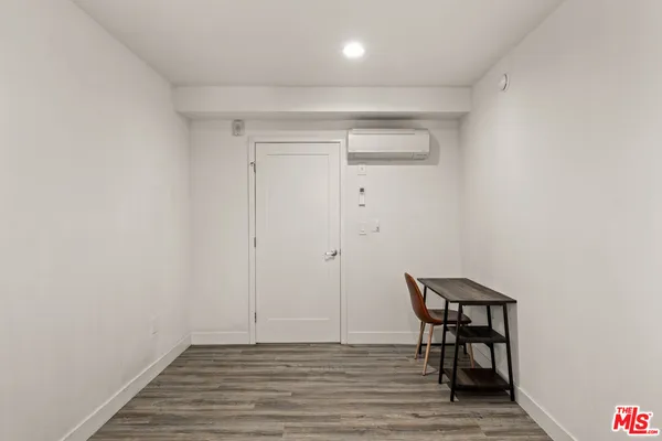 a bedroom with a bed and a tv
